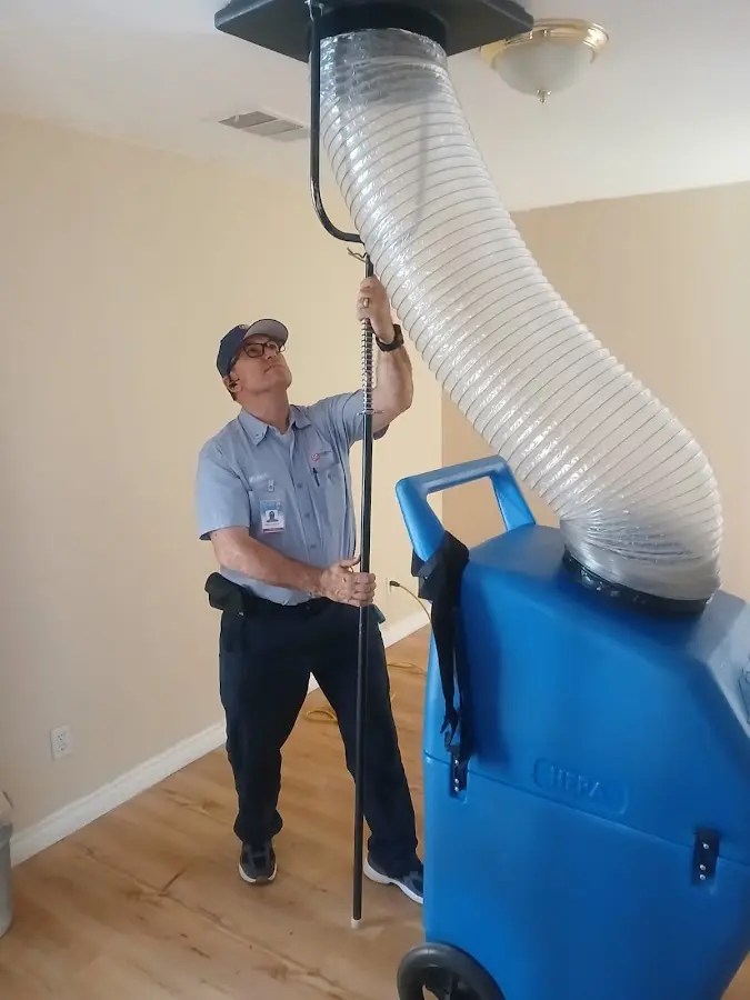 Furnace Tune-Up technician using HEPA equipment in Madison